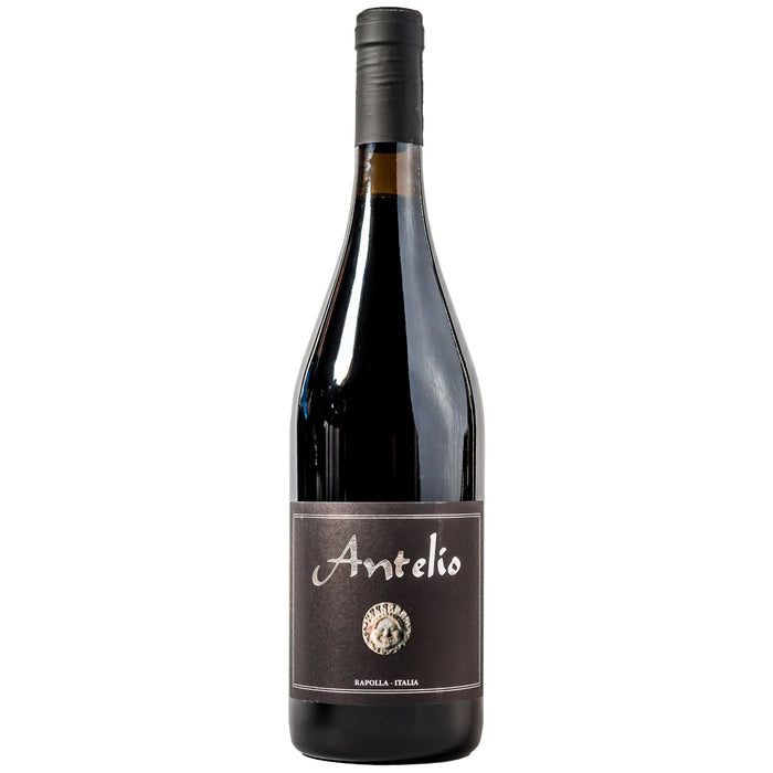 Red wine bottle with black cap and Antelio label on dark glass