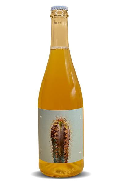 Sparkling white wine bottle with blue cap and cactus graphic label