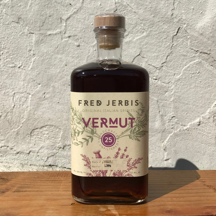 Fred Jerbis vermut 25 bottle with dark amber liquid and illustrated label