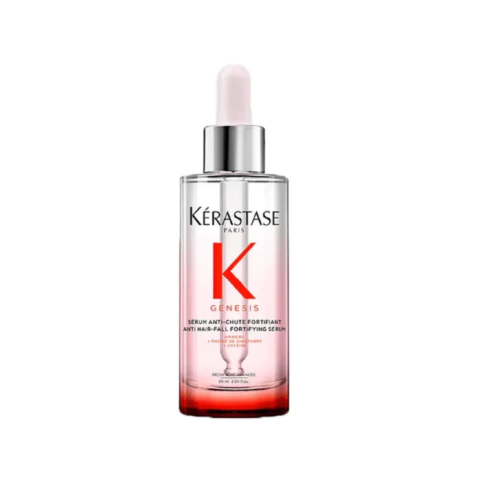 A bottle of Kérastase Genesis serum designed for anti-hair-fall fortification, with a white dropper tip on a red and clear liquid.