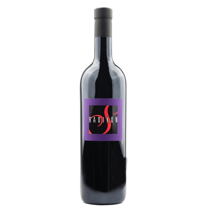 Radikon wine bottle with purple label and black cap, dark glass