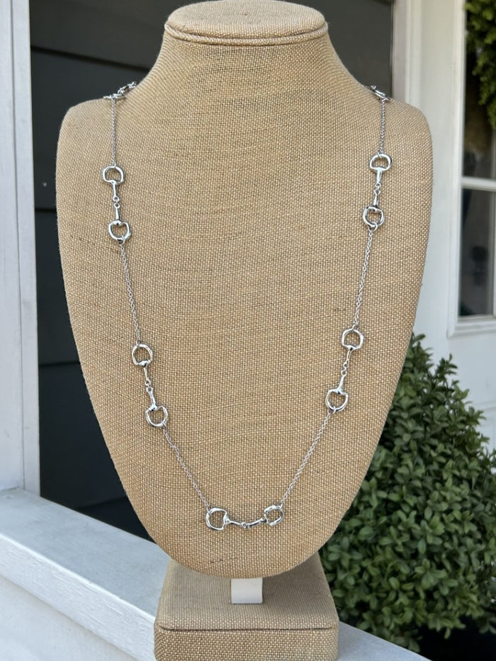 Elegant long necklace featuring delicate silver chain adorned with charming equestrian boot accents. A sophisticated choice for horse enthusiasts who appreciate distinctive jewelry with meaningful detail. The extended length offers versatile styling options, whether worn layered or as a standalone statement piece. Perfect for adding a touch of equestrian elegance to any wardrobe.
Approximate Length: 34-36"
Note: Silver N' Accessories jewelry is brass and stainless steel with rhodium and 18 KT gold plated.