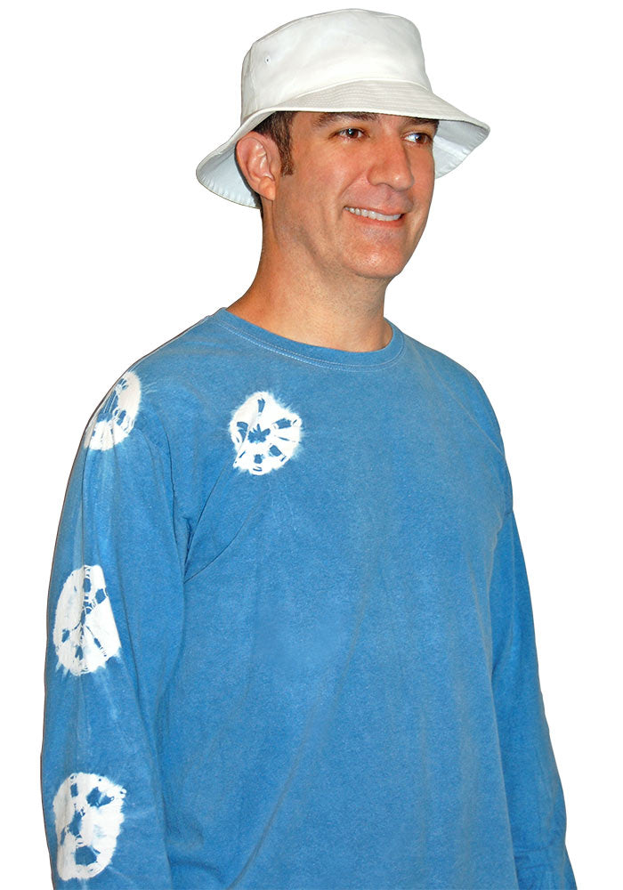 Quarter turn view of man wearing a white bucket hat and blue long-sleeve shirt on a white background.