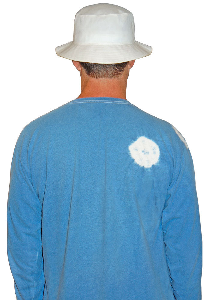 Person wearing a white bucket hat and 
blue long-sleeve shirt with a white logo on the back, facing away from the camera.