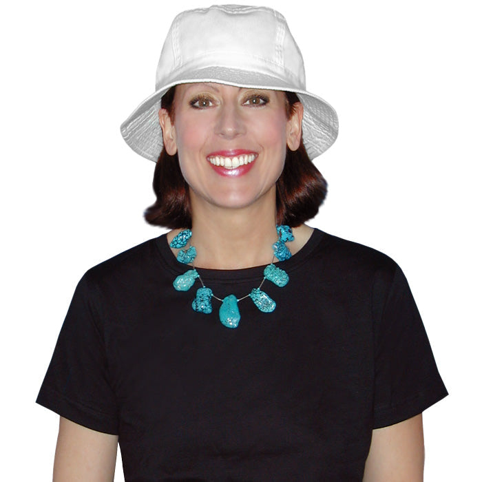 Woman wearing a white bucket hat and black shirt with a blue necklace on a white background.