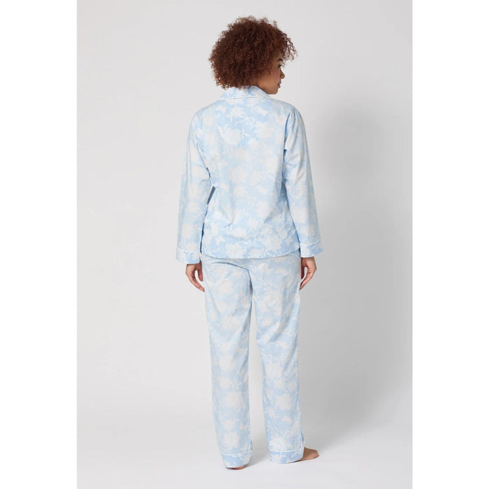 Person wearing a light blue pajama set on a white background
