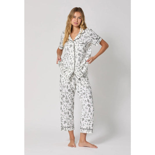 Woman wearing a patterned pajama set on a white background