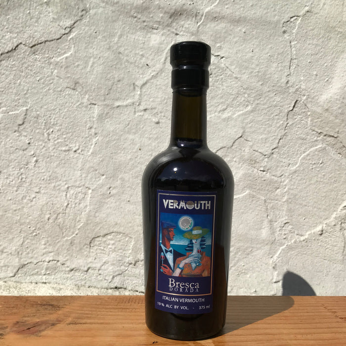 Dark glass vermouth bottle with black cap and front label