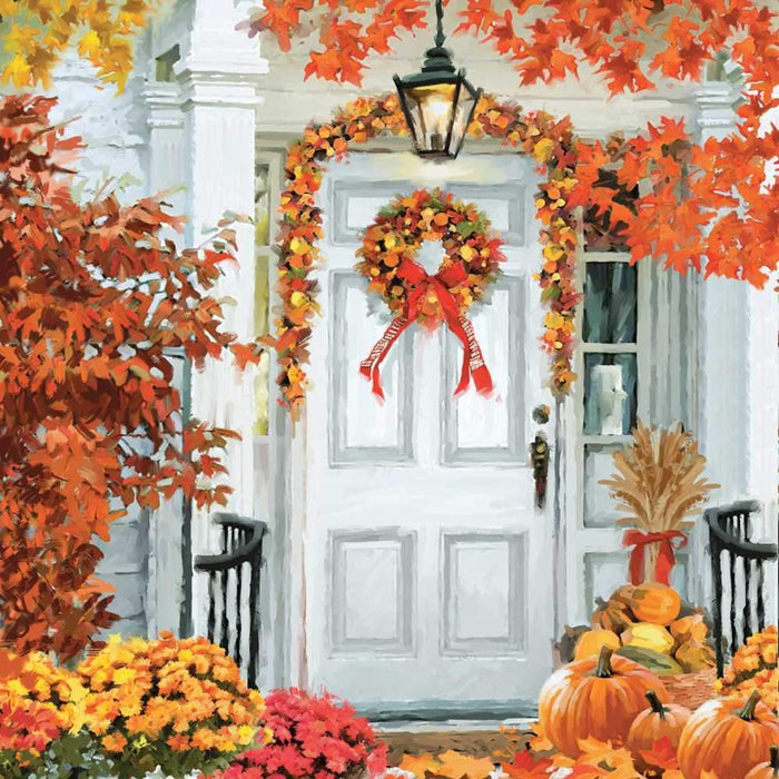 Scene of a white front door featuring a wreath and garland made of fall leaves in yellows, oranges and browns. Pumpkins and mums are decoratively placed on the porch.