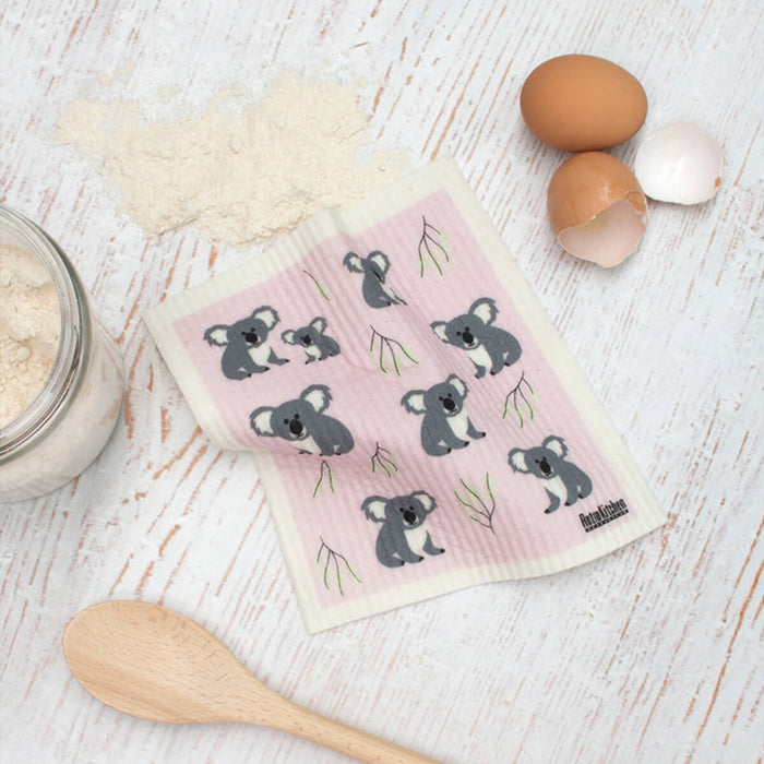 Compostable sponge cloth with a koala design on a bench.