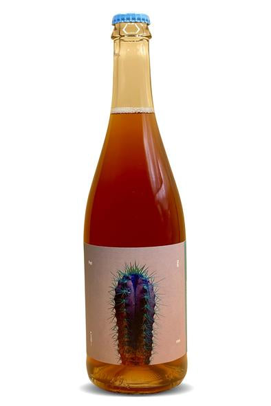 Rosato sparkling wine bottle with blue cap and feather artwork label