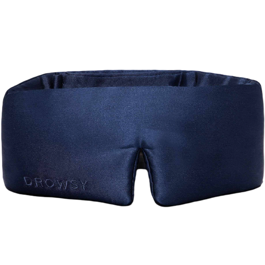 Navy blue sleep mask with 'Drowsy' branding on a white background