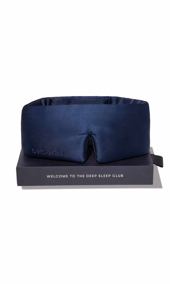 Navy blue sleep mask on a black stand with 'UHOO' branding and text on a white background