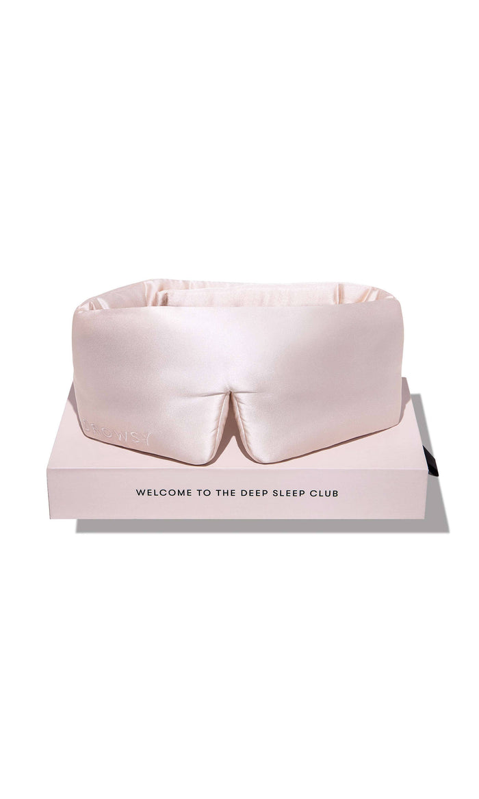 Pink satin eye mask on a white background with text 'Welcome to the Deep Sleep Club'.