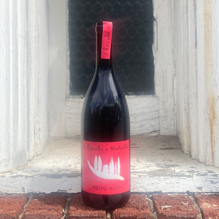 Dark wine bottle with red label and small neck tag
