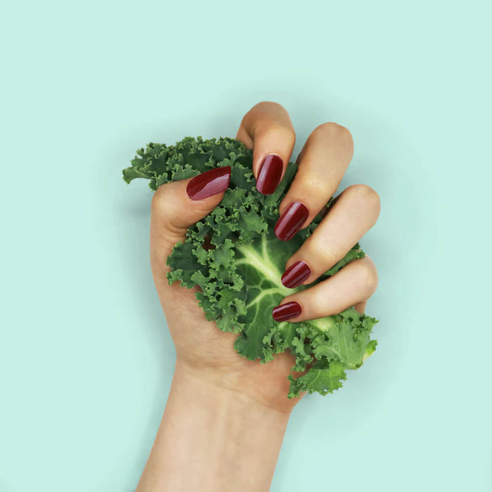 Nails painted with non-toxic, deep dark red nail polish with kale protein infusion.
