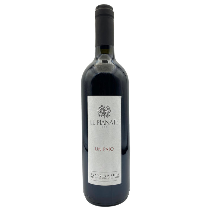 Red wine bottle with dark glass and label reading Le Pianate Un Paio