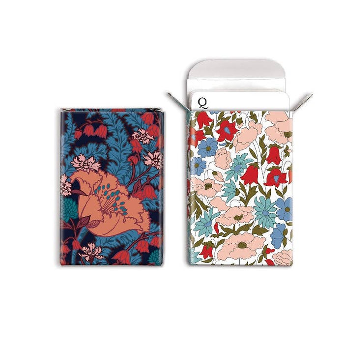 Two floral-patterned card decks on a white background