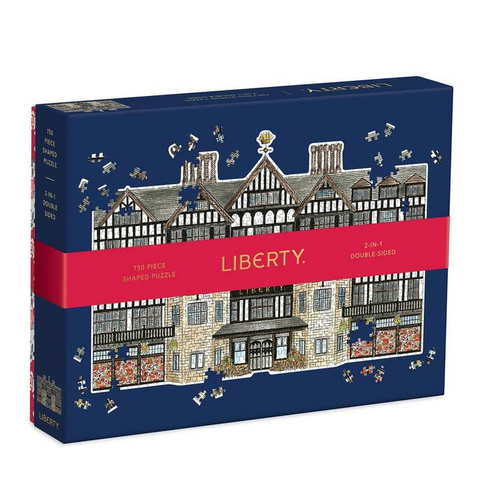 Jigsaw puzzle box with Liberty branding and architectural design on a blue background