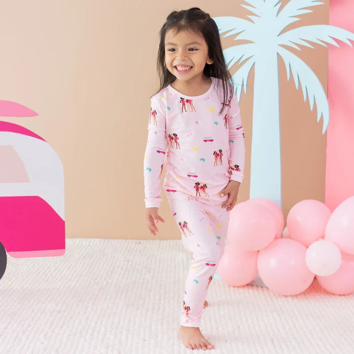 Girl wearing Kyte Baby Barbie™ Beach long sleeve pajamas in soft breathable bamboo fabric.