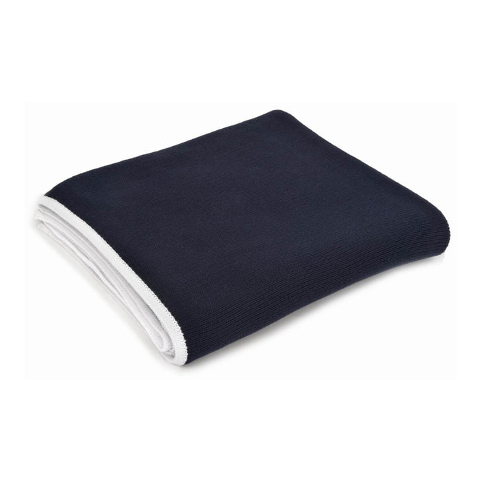 Folded dark blue blanket with white trim on a white background
