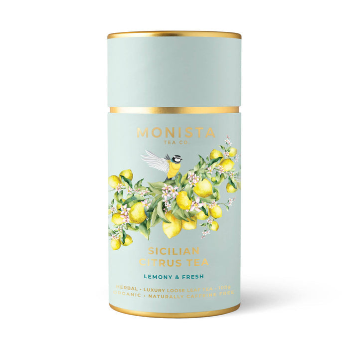 Tea canister with lemon design and 'Monista Tea Co' branding on a light blue background