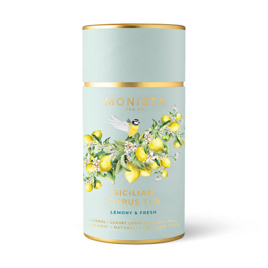 Tea canister with lemon design and 'Monista Tea Co' branding on a light blue background