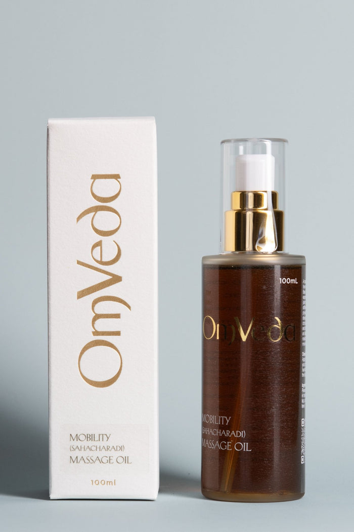 OmVeda body oil 100ml bottle with carton, dark amber liquid and gold pump