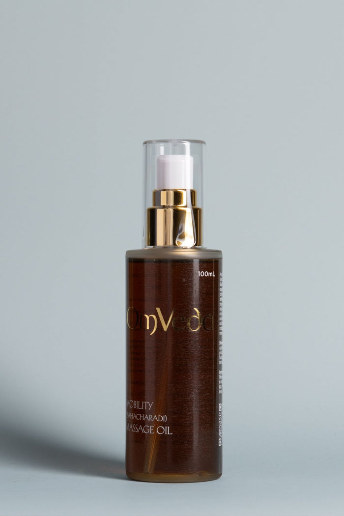 OmVeda body oil 100ml bottle with gold pump, dark amber massage oil in glass
