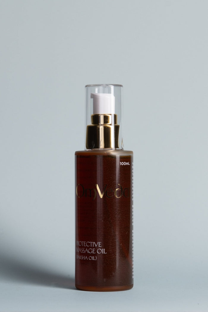 Protective massage oil in dark amber bottle with gold pump, 100 ml