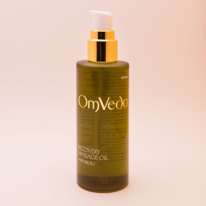 OmVeda recovery body oil 100 ml bottle with gold pump and amber-green liquid
