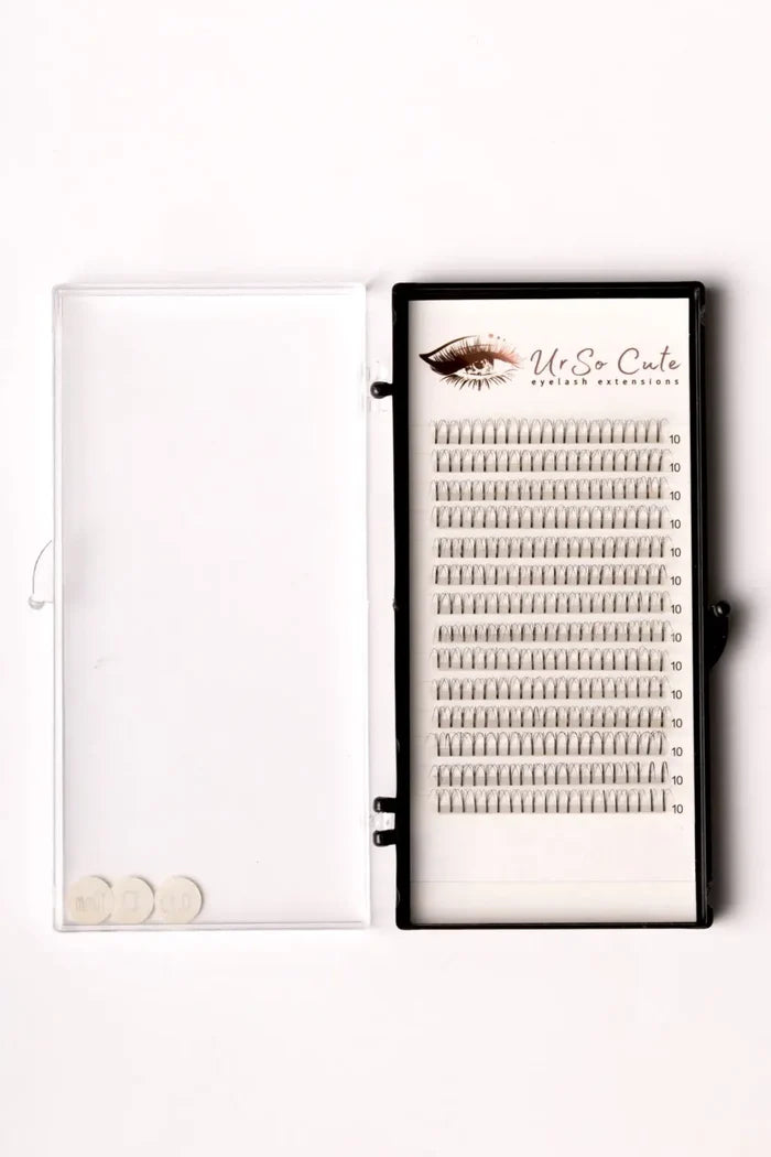 Black-framed tray of silver pre-made fan lashes 4d branded ur so cute arranged in rows for eyelash extensions