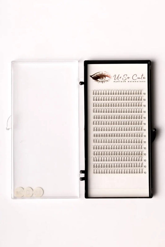 Black-framed tray of silver pre-made fan lashes 4d branded ur so cute arranged in rows for eyelash extensions