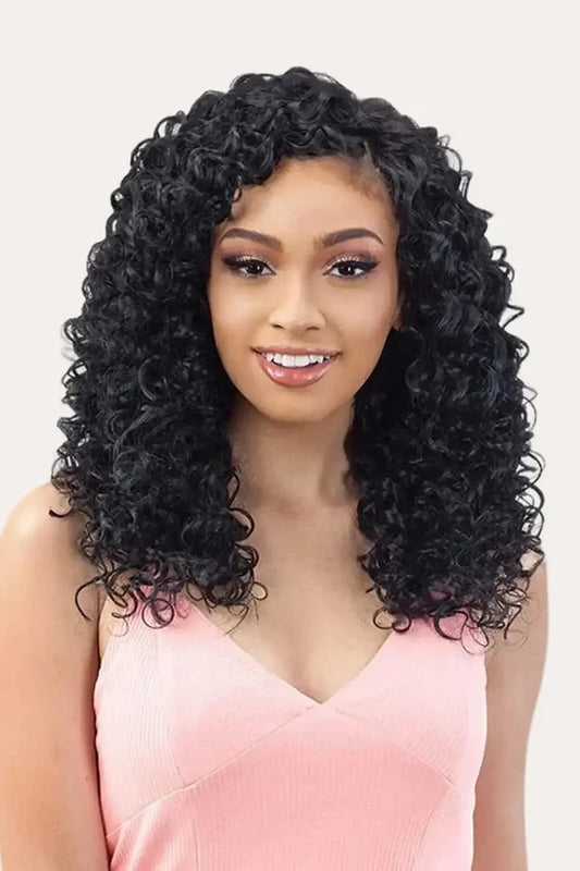 Model wearing Shake-N-Go Organique Hawaiian Curl 24 inch weave styled to look like voluminous long curly human hair.