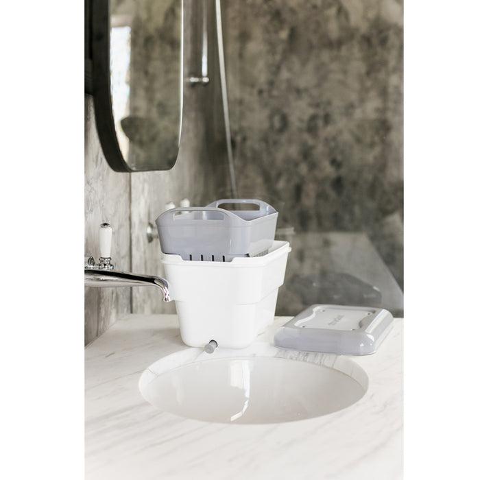 Raise the strainer out of the bucket to allow items to drip dry while the built-in drain plug empties easily.