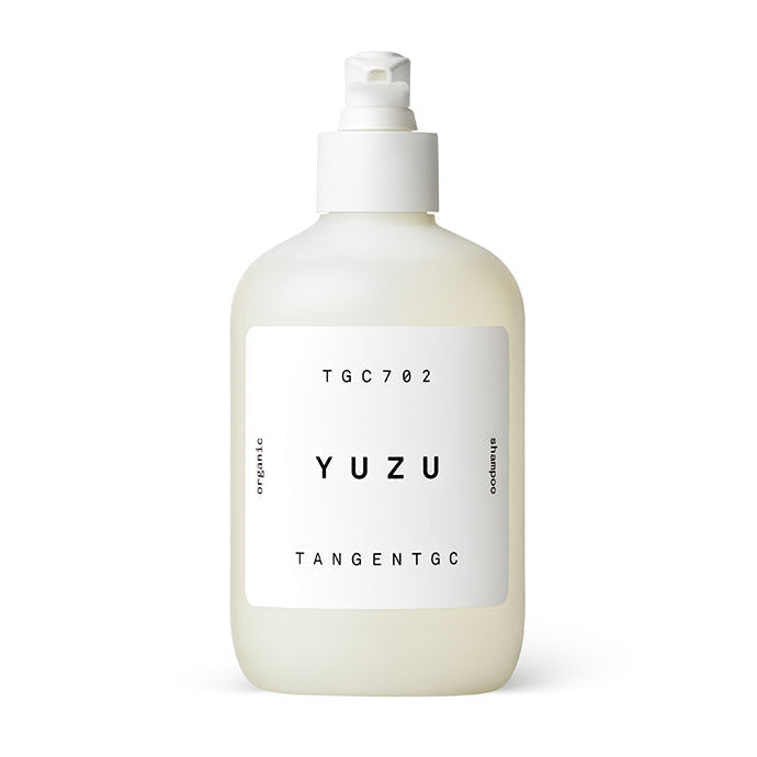 A bottle of Tangent GC Yuzu Shampoo with a white pump dispenser, labeled with the product name and volume.