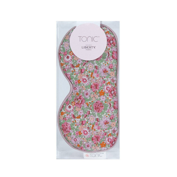 A floral patterned eye mask by Tonic Australia, with a tag showing 'Liberty'.