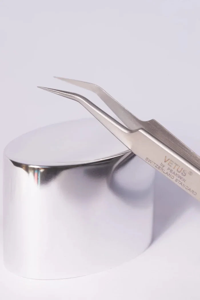 Silver Vetus precision tweezers with curved pointed tips and sleek metallic finish ideal for hypoallergenic adhesive glue use